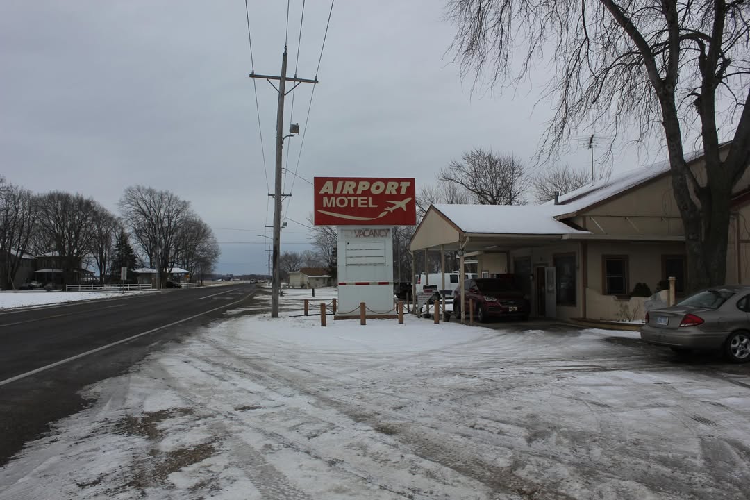 CorrieCarb5s's tweet photo. Tonight, I’m sharing the old Airport Motel in Lawrence, KS, demolished in 2021. Its iconic roadside sign is now gone too—a shame, because it was one of the coolest I’ve seen. Photos taken February 15, 2020. R. I. P. Glen Hansard https://t.co/NhNvwzyuU6