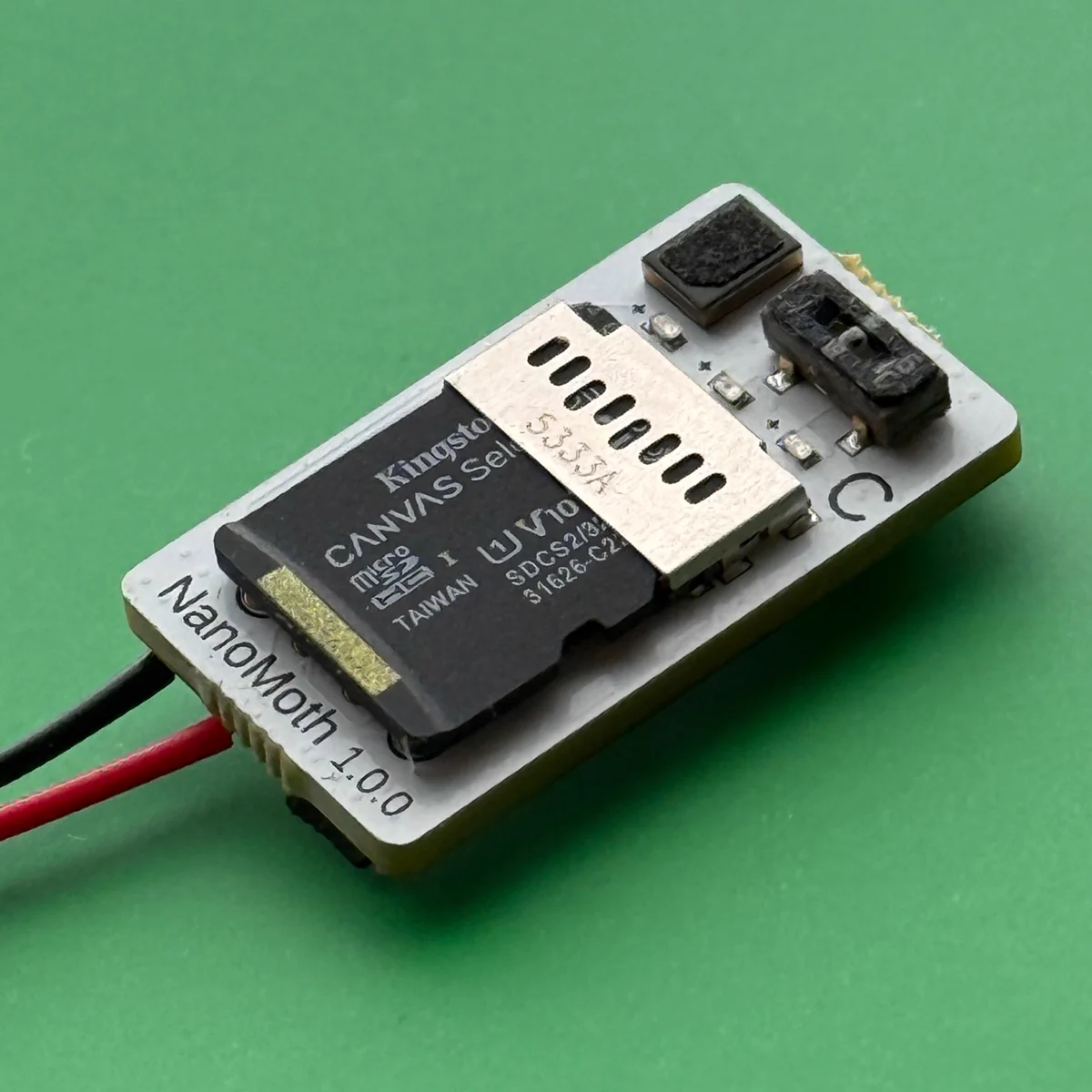 Photographs of a NanoMoth prototype printed circuit board against a green background.