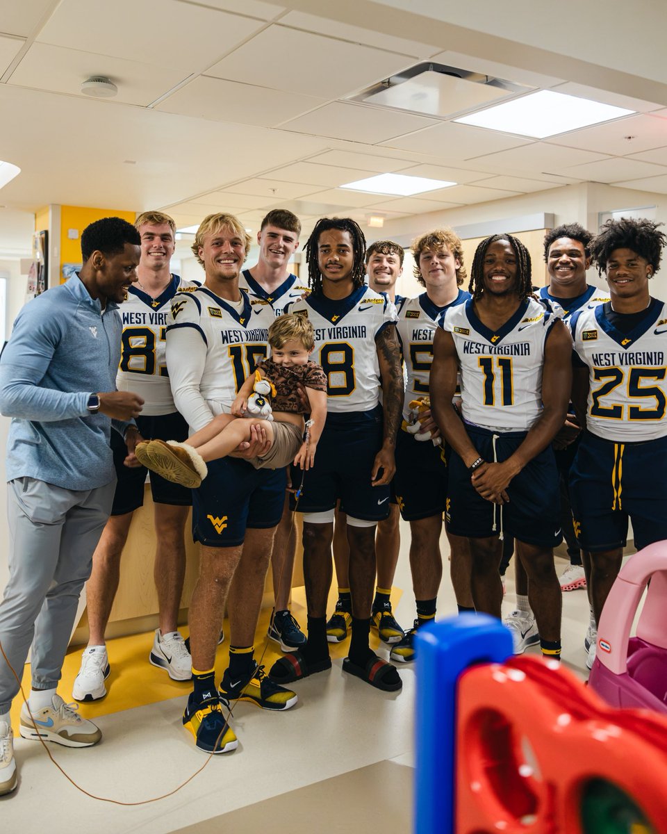 WVUfootball's tweet photo. Great time with our friends at WVU Medicine Golisano Children’s Hospital 💛💙 https://t.co/w03B93lgIX