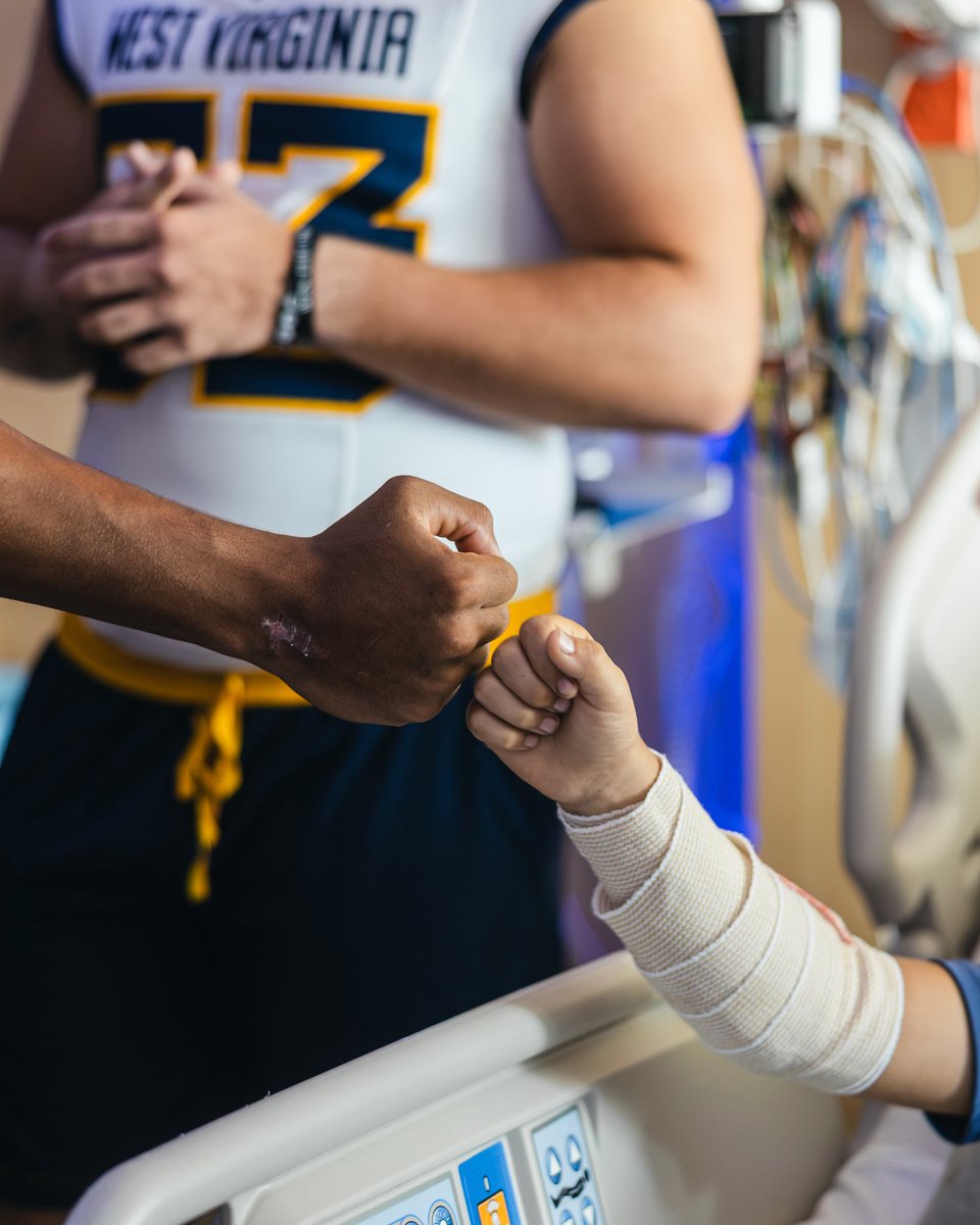 WVUfootball's tweet photo. Great time with our friends at WVU Medicine Golisano Children’s Hospital 💛💙 https://t.co/w03B93lgIX