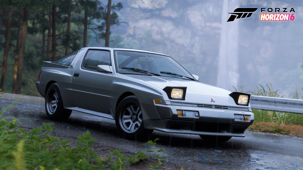 A silver Mitsubishi sports car is parked on a wet road surrounded by greenery. A waterfall is visible in the background. The Forza Horizon 6 logo is in the top right corner.