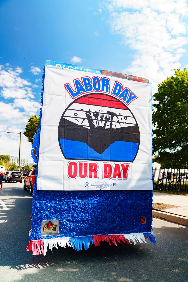 Labor Day sign on a float in a parade.