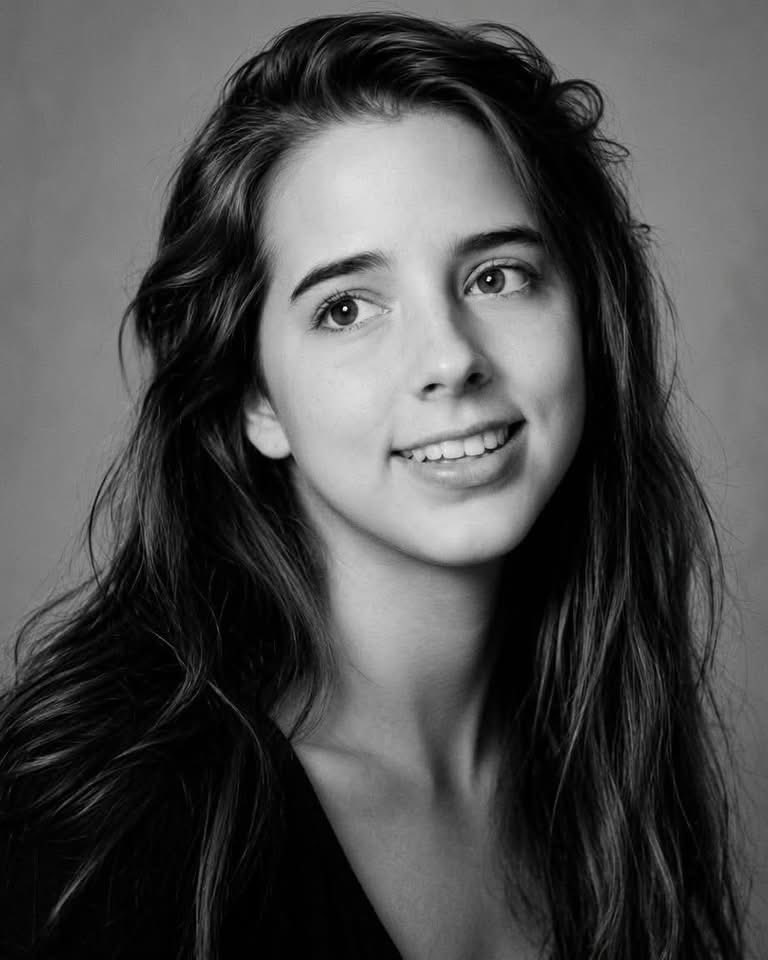 AlGeneRobi96834's tweet photo. She was 27 years old.

Twenty-seven.

An age when you are supposed to be planning what comes next, not making peace with the end.

Her name was Honor Elizabeth Wainio.

Everyone called her Lizz.

And on September 11, 2001, in the final minutes of her life, Lizz did something almost incomprehensible.

She tried to comfort everyone else.

Just two days earlier, she had been in Paris.

She had walked the Champs-Élysées. She had attended a friend’s wedding in Florence. She had stepped inside a church and lit a candle for her grandmother.

She once told her mother that if she ever got to see Paris, she could die happy.

She had no idea how haunting those words would become.

On September 11, Lizz boarded United Airlines Flight 93 in Newark, headed for San Francisco.

She had a career. People who loved her. Plans waiting for her on the other side of that flight.

Then, at 9:28 that morning, everything changed.

The cockpit was overtaken. The aircraft plunged. Passengers were forced toward the rear.

Then the people aboard Flight 93 began making phone calls.

And they learned the truth.

Other aircraft had struck the World Trade Center. Another had struck the Pentagon.

Suddenly these ordinary Americans understood something terrifying.

Nobody was coming to negotiate their way out of this.

Their airplane itself was the weapon.

Someone handed Lizz a phone and told her:

“Call someone you love.”

Think about that sentence.

Not call the police.

Not call your employer.

Not call somebody who can fix this.

Call someone you love.

Because time was disappearing.

Lizz called her stepmother, Esther.

And somehow, with everything happening around her, this 27-year-old woman turned her attention away from herself.

She said:

“This is going to be so much harder for you than it is for me.”

That sentence wrecks me.

Because imagine the love required to stare directly into your own final moments and think first about the people who will have to wake up tomorrow without you.

Lizz wasn’t asking to be comforted.

She was comforting them.

She told Esther:

“I’m gonna be with Grandma.”

The same grandmother for whom she had lit a candle in Europe only days earlier.

There is something almost numinous about that.

Then, aboard Flight 93, ordinary people began doing something extraordinary.

They understood what was happening.

They understood what the hijackers intended.

And they made a decision.

If they could not save themselves, they might still save people they would never meet.

Parents.

Children.

Secretaries.

Police officers.

Tourists.

People walking through Washington who would never know the names of the strangers fighting for them thousands of feet above Pennsylvania.

Flight attendant Sandra Bradshaw told her husband she was preparing boiling water.

Todd Beamer prayed the Lord’s Prayer.

Then came the words America would remember:

“Let’s roll.”

These were not soldiers boarding that airplane that morning.

They were ordinary Americans.

They had luggage.

Appointments.

Families.

Wedding memories.

Vacations.

Coffee cups.

Plans for Wednesday.

And suddenly history placed an impossible burden upon them.

They carried it anyway.

Lizz returned to the phone one final time.

“They’re getting ready to break into the cockpit. I have to go. I love you. Good-bye.”

Read those words slowly.

“I have to go.”

She knew where she was going.

She knew what those passengers were preparing to do.

And still:

“I love you.”

At 10:03 a.m., Flight 93 came down in a field near Shanksville, Pennsylvania.

It never reached Washington.

Forty passengers and crew did not come home.

But countless other Americans did.

That distinction matters.

Today, at the Flight 93 National Memorial, the Tower of Voices contains 40 wind chimes.

Forty individual voices.

Forty human beings.

Not statistics.

Not merely names carved into stone.

Sons.

Daughters.

Mothers.

Fathers.

Husbands.

Wives.

Friends.