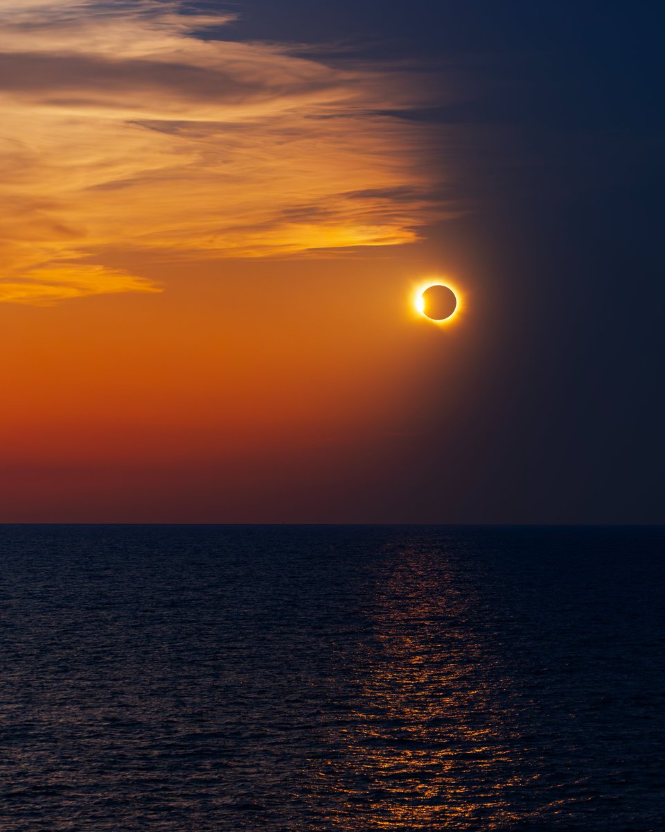 _cosmicearth's tweet photo. My favorite capture of the night: The moment the moon's shadow split the sunset in half, leaving a diamond ring in the sky and a breathtaking view. I call it "Shadows on the Balearic Sea".

I'll have prints available for this one linked in my bio for a few days only.
Image Credit 
Andrew McCarthy