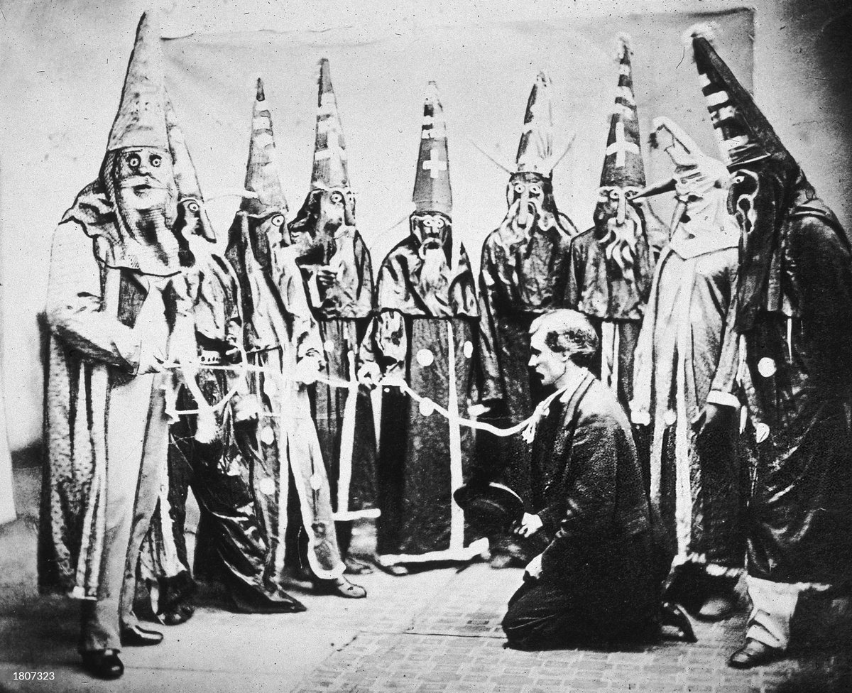 MonasteryRaider's tweet photo. Attached below is an 1871 photograph titled "The contemplated murder of John Campbell" taken at Watson’s Photograph Studio in Raleigh.

This is a recreation of an earlier event that unfolded in the woods of Moore County, North Carolina.

The man in the middle, John A. Campbell, was a prominent racial-equalitist Republican politician in the area, and therefor an enemy to the local Democratic population. The Klan of course would not stand for this.

On the night of August 10th, 1871 the men of the local Kuklos abducted Mr. Campbell from his home wearing the exact garment you see below, they dragged him into the woods and prepared to try him for racial treason. The evidence of course being his party affiliation, which was no secret.

They of course found him guilty, the punishment?Death. They tied a rope around his neck and prepared to hang him for his crimes against the state, his race, and the southern way of life.

Present at the scene was their fellow Klansman, Joseph G. Hester. What they did not know about Mr.  Hester is that he was also a US detective that had infiltrated their group.

The subsequent events aren't very well documented but what we do know is that he freed Mr. Campbell and arrested the Klansmen at the scene.

The costumes that these Klansmen were wearing were all taken as evidence. The photo below, paid for by Mr. Hester, shows the real costumes being worn by actors to recreate the scene that had unfolded, they planned to use the scene as some sort of anti-Klan propaganda. Mr. Campbell himself posed in the middle of the photo.

This is one of the only surviving photos of the original Ku-Klux-Klan or their garments, sadly we do not know the fate of these costumes nor much else about Mr. Campbell.

In the comments i will leave a closer photo of one of the costumes aswell as a drawing of the event.