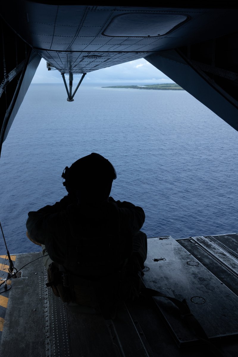 IIIMEF's tweet photo. U.S. Marine Corps Staff Sgt. Bret Lafferty, a crew chief with 1st Marine Aircraft Wing, looks out the back a CH-53E Super Stallion helicopter over Okinawa, Japan, Aug. 20, 2026.  @1stMAW_Marines https://t.co/a1yferuwgK