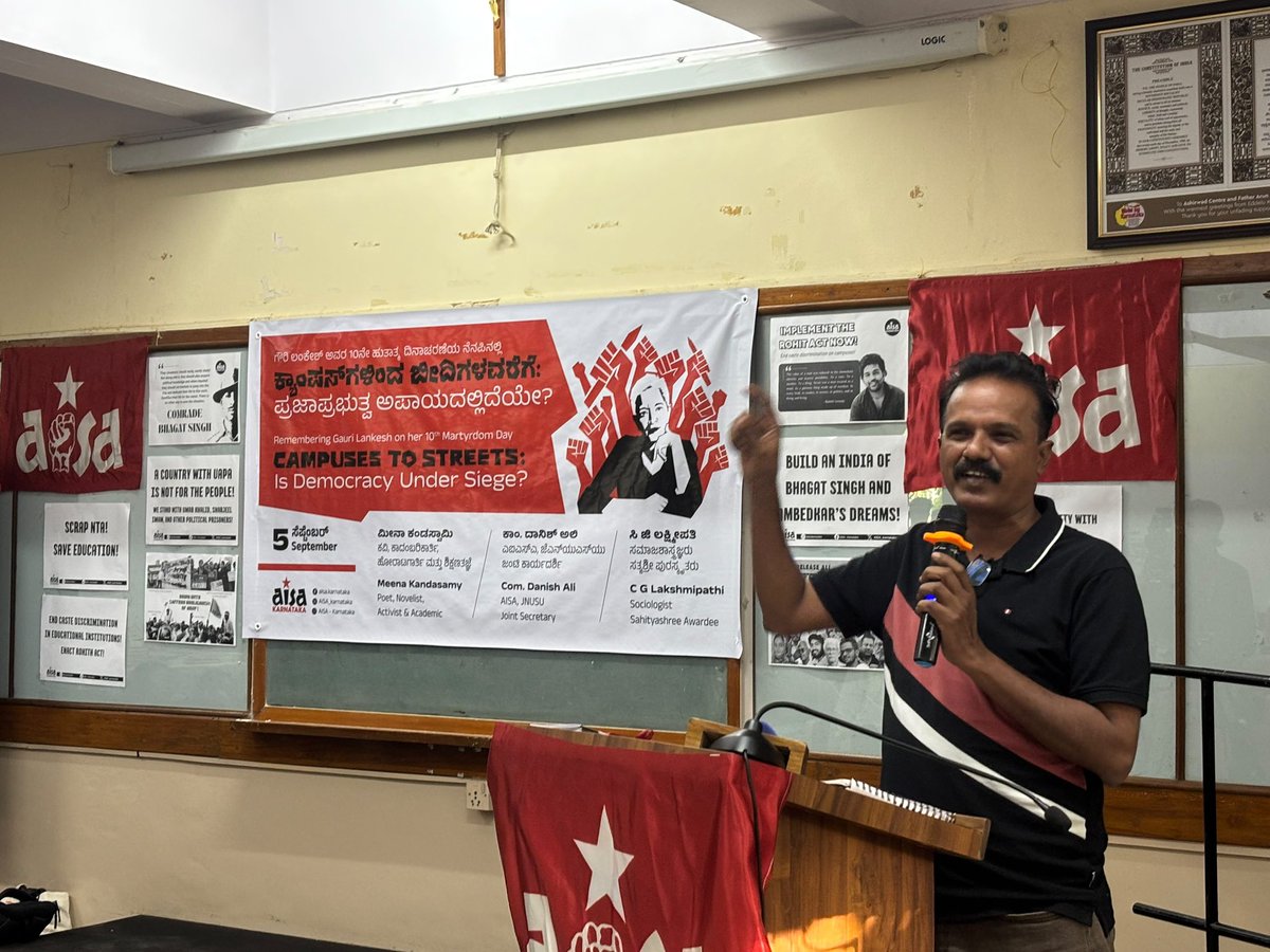 newstapworld's tweet photo. Bengaluru: AISA organised “Campuses to Streets: Is Democracy Under Siege?”, bringing together students, activists and academics to discuss dissent, democracy and what speakers described as growing attacks on public education and democratic spaces under the BJP-led government.

JNUSU Secretary Com. Danish Ali recalled the courage and legacy of Gauri Lankesh, warning that activists and dissenters increasingly face repression for speaking against the government. She criticised the growing privatisation and saffronisation of education and said student participation in politics was essential to defending democratic rights.

Sociologist Dr Lakshmipathi C G spoke about caste discrimination and communal divisions within educational institutions, saying classrooms were increasingly turning into “caste-rooms” and “communal-rooms.” He also criticised the growing privatisation of education in Karnataka and the weakening of scientific thinking.

Author Meena Kandasamy spoke on censorship and the shrinking space for dissent, referring to Gauri Lankesh’s assassination as a chilling moment for activists and journalists. She argued that attempts to label and delegitimise dissenting voices were being used to suppress ideas that challenged the dominant political ideology.

The programme also saw the launch of AISA’s booklet, “Education Under Siege,” examining the condition of education in India with a special focus on Karnataka. The evening concluded with a cultural performance by AISA members and drew an audience of over 150 people.

@AISA_tweets @AISA_karnataka @meenakandasamy