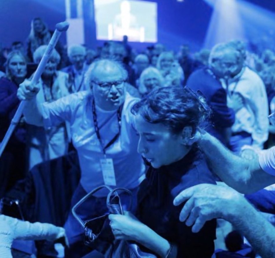 KateWilton1's tweet photo. The pictures from Reform conference of delegates assaulting women protestors should be front page news. There should be no excuses because of their age. This is where the country is heading under Farage and Reform. These are the people who have been radicalised in this country. https://t.co/UghsB6OyjR