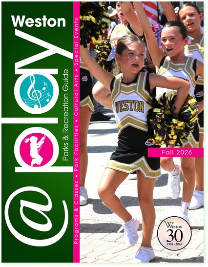 Young cheerleaders in black and gold Weston uniforms performing at an outdoor event during the day.