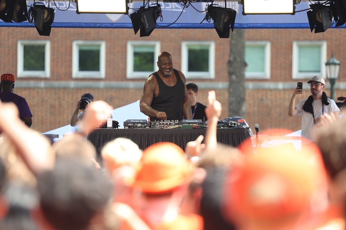 Shaquille O'Neal is performing as a DJ on an outdoor stage at UVA.