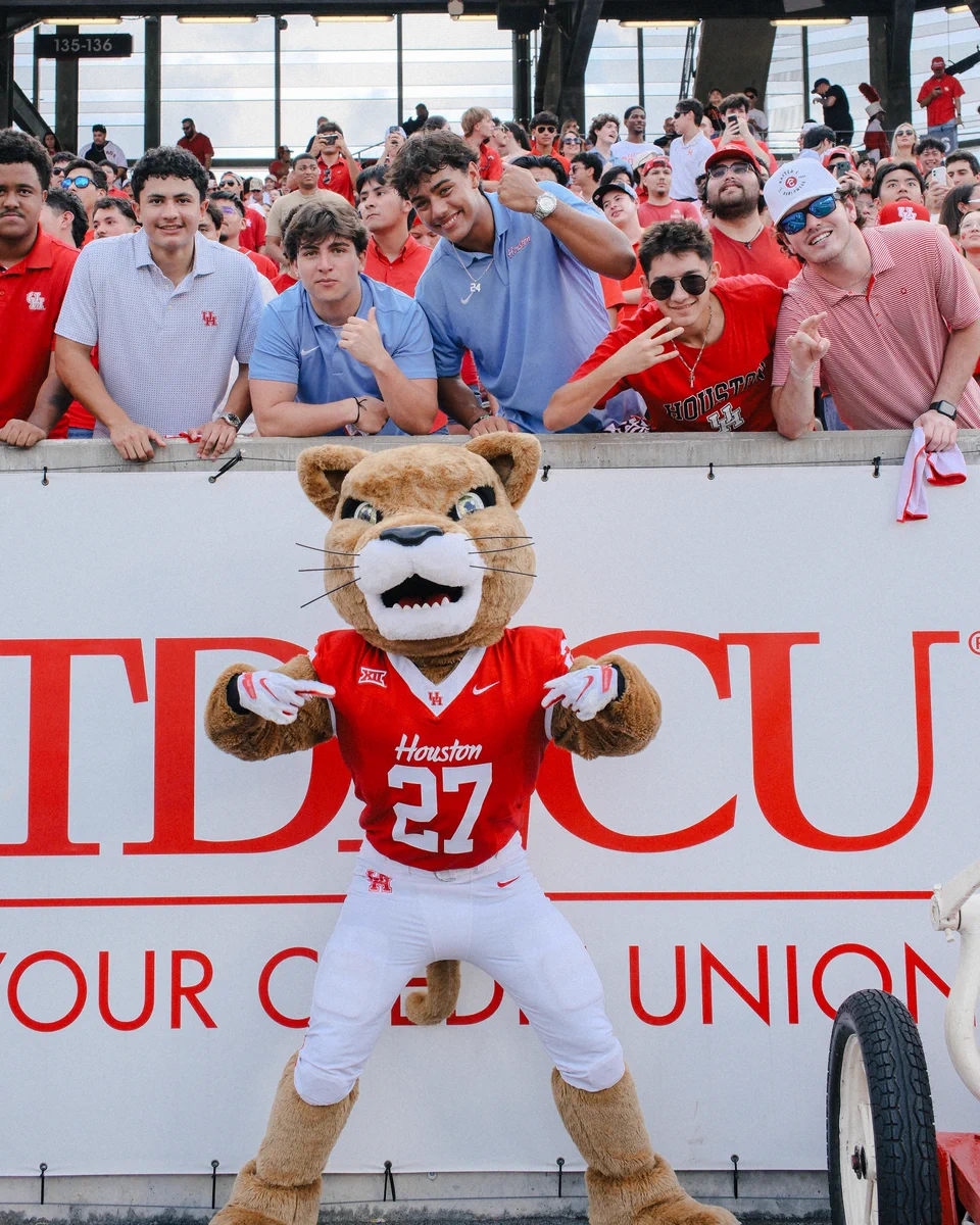 Shasta poses with fans at TDECU Stadium.
