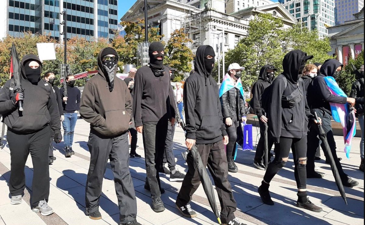 AjaTheEmpress's tweet photo. I do feel the need to point out that these are all the same picture:

1) Men in Dover today
2) Muslim men
3) Trans rights activists
4) Antifa

Some people only seem to have noticed or cared about No. 1.

I don't like any of it, regardless of who's doing it or what label is attached to them.

It is intimidating AF when you're on the wrong side of a group like this, and sadly, like many other women, I have experienced that from groups 3 and 4.

The standard should be the same for everyone. No face covering allowed.