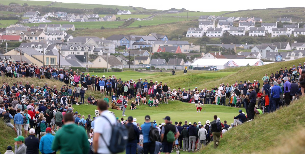 jamierkennedy's tweet photo. Observations from Saturday at Lahinch 🇮🇪

1. Holy shit, the crowds. Only 1,000 people live in Lahinch and yet, there's more than 8,000 people walking every fairway, surrounding every green. It's manic at times but it works and creates a really unique atmosphere. No booing or bad blood, just a bunch of golf fans walking with really, really good golfers.

2. Wild how still it was this morning considering the weather we had the last three days. When the first ball was hit, there wasn't a single flag moving. GB&I were 15-under par in the 4 foursomes matches this morning, and the only team that lost was 5-under when they lost. Fear not, the challenging weather is forecasted to return tomorrow!

3. What a day for Niall Sheils Donegan. Rules controversy, a perfect 2-0 record with smiles and shotmaking throughout. Nice line after saying he's glad it was foursomes and he didn't have to tee off after his "brainfart" on the non-conceded putt. Said he was running a little too hot to hit a controlled drive on the next hole. Very likeable lad though and visibly bigger and stronger than last year at Cypress.

4. The 13th hole at Lahinch is great and even better in match play. Just 300 yards, loads of undulation and awkward spots around the green. Fun front pin today with run offs short and right. Also a great place to watch golf. I watched five groups this afternoon through there.

5. How big are the dunes at Lahinch? There was supposedly 1,500 kids out there today. I'd say most of them had a go at sliding down several different dunes. Full send, frontal slides, cruising 40-50 yards down into the rough.

6. It's fun watching guys try and "bunt" drives and iron shots. Sort of off-speed shots to get under the wind and run. Grehan, Donegan and Hagestad seem to have it mastered. If the wind gets up tomorrow, that control will be key.

7. The uniforms this week, on both sides, are so cool. Both by Peter Millar. Muted colours, retro looks for both teams but still simple and classy. Not sure why they don't sell the gear on-site but one player told me "I got three suitcases full of it, it's awesome."

8. Mad how there can be 8,000 spectators on a golf course and it seems every one of them knows each other. Plenty of drinks and laughs yet it's all about the golf. 

9. Really hope the GB&I lads get it done tomorrow. Yes, to stop the run of U.S. wins but also because there's about 12 pubs on the high street in Lahinch that would be perfect for a post-victory team night out!