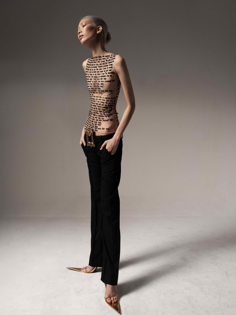 itsbleekerxox's tweet photo. The top is originally hand embroidered by small Vietnamese designer DATT &amp; came with matching gloves. It's intentionally made with sheer chiffon to mimic tattooed artwork.

Its 2022 Popularity brought mass produced knock-offs of cheaper white tees that screen print instead ☹️ https://t.co/CC66lMwDv0