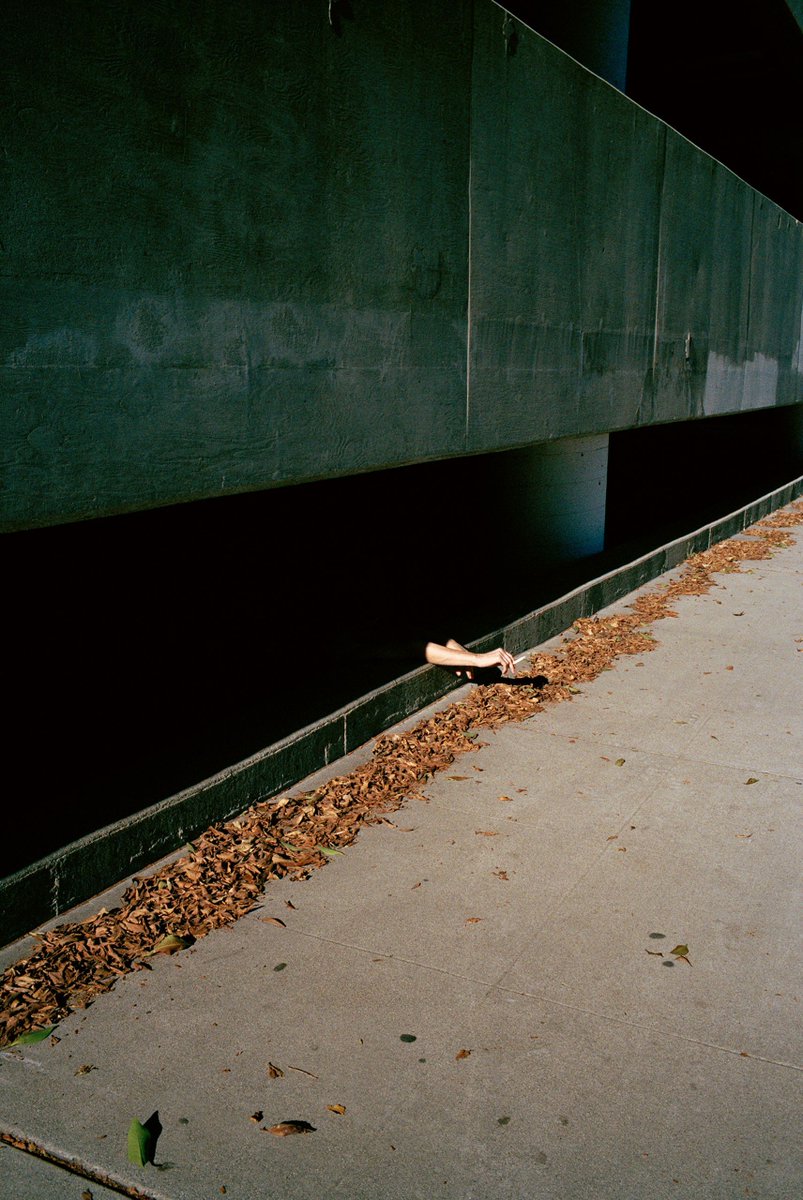 NewYorker's tweet photo. In his photographs, the skateboarder Jerry Hsu captures Los Angeles’s manic extremes. He maps a city of leftovers and castoffs; portraits of friends and strangers in the street are full of dazed, inscrutable expressions. Many of his images, even the faintly violent ones, possess an absurdist humor. “Maybe this is corny,” Hsu said, “but all this chaos and these little beautiful secrets I found here reminded me of myself.” See more of his photos: https://t.co/T5AjVmEC6E