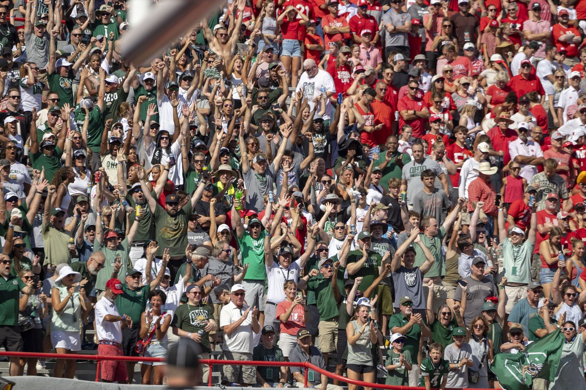 OhioFootball's tweet photo. A section of green never goes unnoticed in a sea of red. 💚 Thank you to every Bobcat who made the trip to Lincoln and showed up for Ohio. We’ll see you Saturday at Peden. #OUohyeah https://t.co/h9mYdEJMXQ