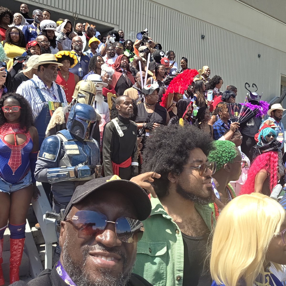 AtlBlerd's tweet photo. A few hrs ago I participated in the #BlackGeeksofDragonCon photoshoot. Hundreds of blerds in various costumes. 

Saw TONS of Viltrumites, Green Lanterns &amp; others. 

Know what I DIDN'T see? #BlackPanther. No T'Challa or #Shuri. #RecastTChalla 

#DragonCon #DragonCon2026 https://t.co/FdpLKOA6LD