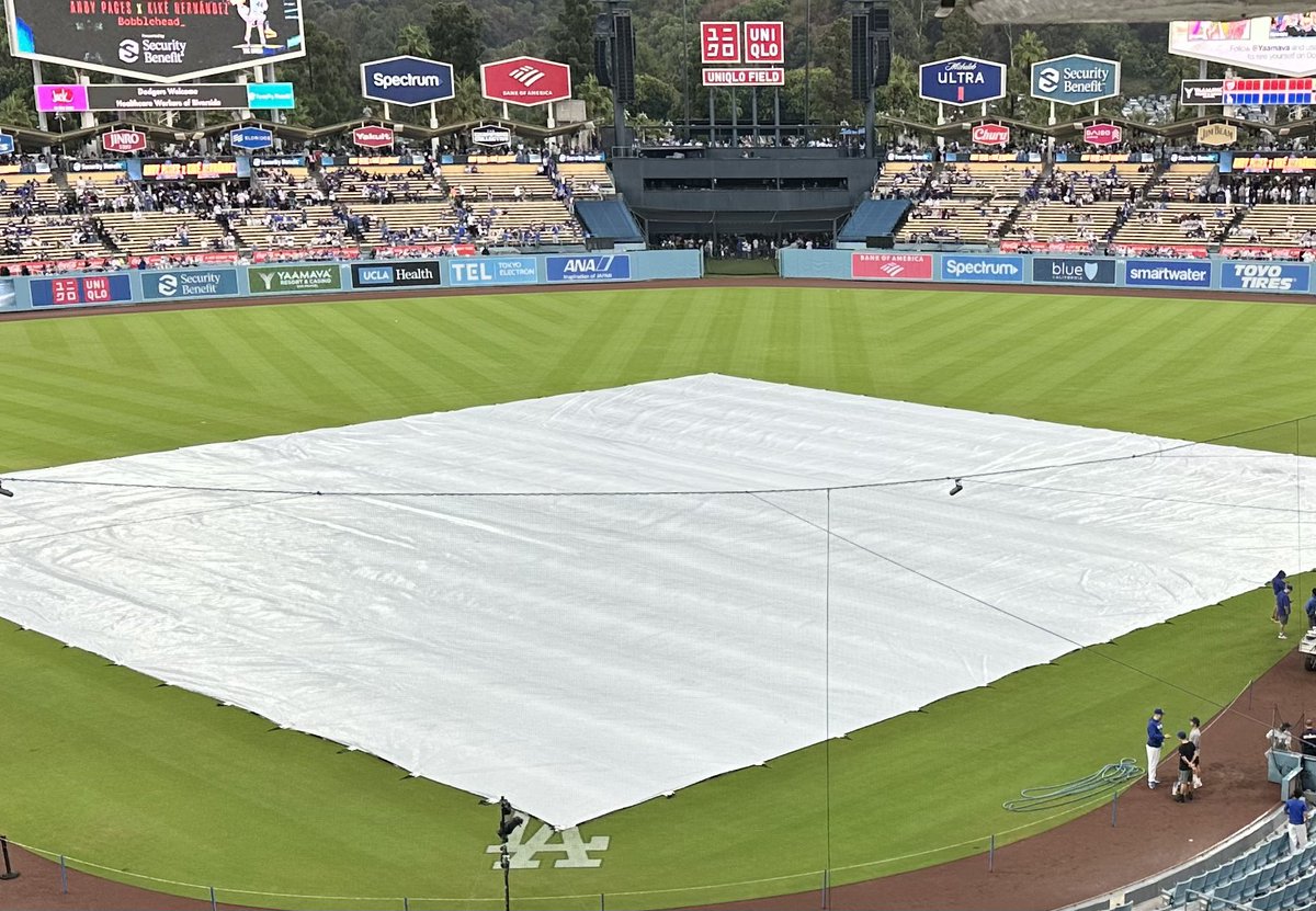 CharlieSlowes's tweet photo. A sight not often seen. Tarp on the field at Dodger Stadium.  But we should have @Nationals-@Dodgers on the radio. 9:40 est on @1067theFan &amp; the Audacy app. https://t.co/VARvZEU1VE