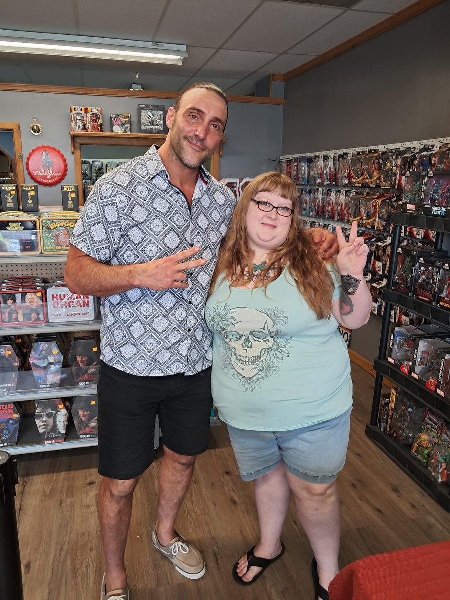 BookProWrestler's tweet photo. “I got to meet Chris Masters and it's still one of the best experiences ever. 

We live in a stupidly small rural area and he took the time to still visit and shoot the breeze with us. 

He spelled my name wrong at first and i joked I'd just change my name to it and he just gave me that print and one with my correct name- and to top it off since I was the first one there he helped picked the best lighting spot for our selfie together. 

We talked about our shared love of HBK and about the very few places to eat here. I joke that he's one of my besties now lol.” 

— Miranda Kallison, BPW Reader