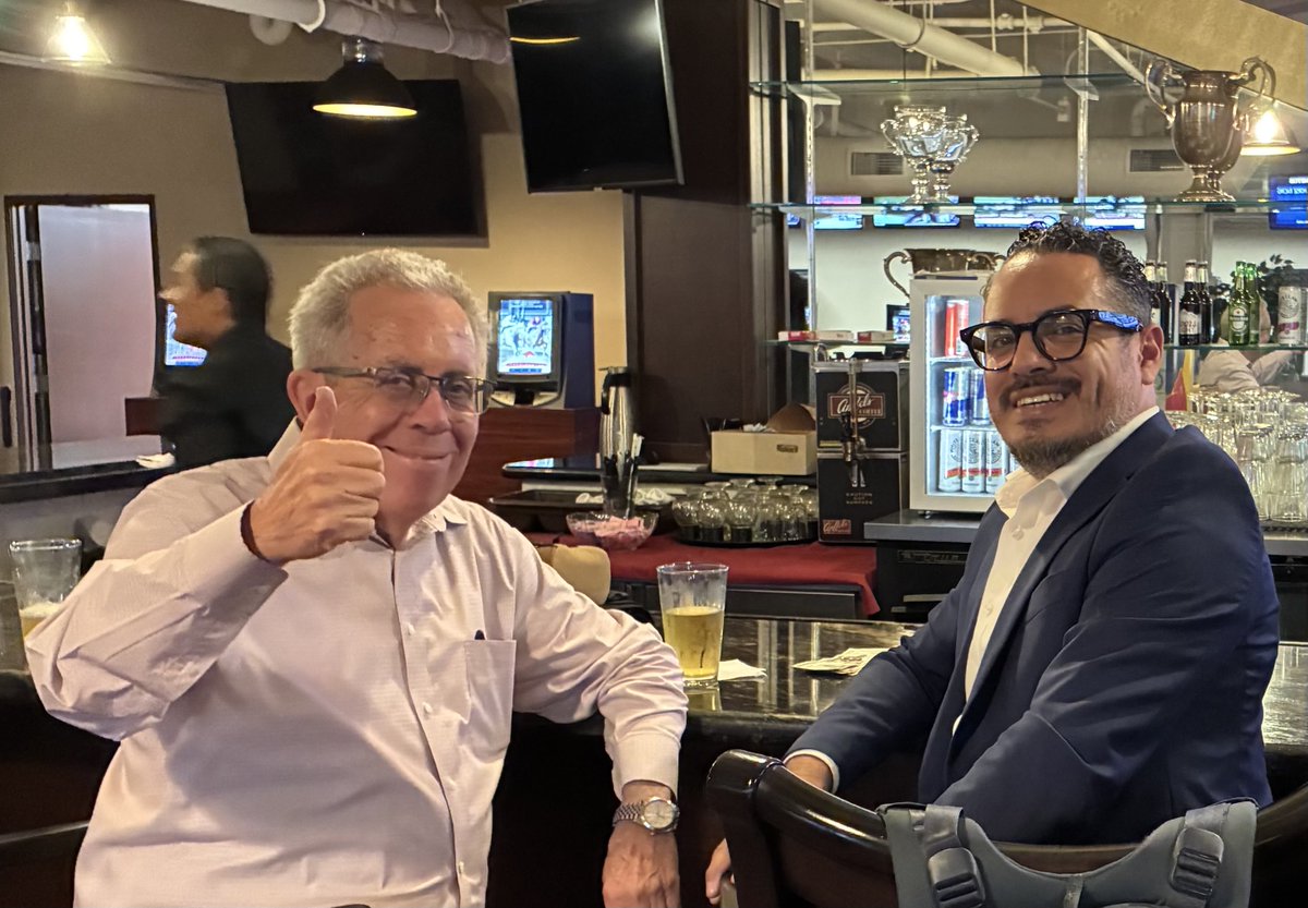 Michael_Wrona's tweet photo. My thanks again to @qheddie for returning to the @losalracing booth the past two weekends. Here is the great man (at the bar named in his honor!) enjoying a well-earned beer with @LosPonies. #GoodFriends #TopBlokes https://t.co/AULvL0XE7h