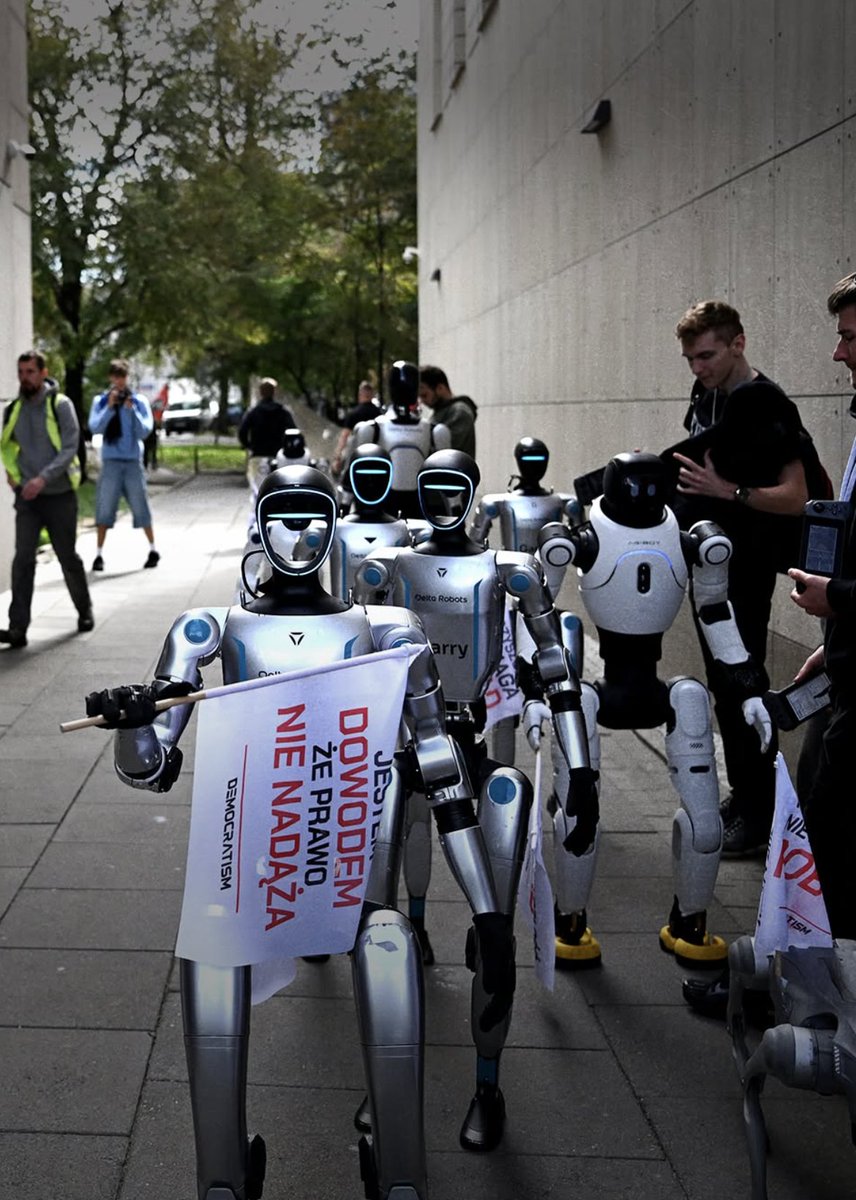 Polymarket's tweet photo. JUST IN: Polish humanoids &amp; quadrupeds take to the streets of Warsaw in a "robot protest" over AI &amp; automation, calling for new rules to protect human jobs from replacement. https://t.co/rDsC0DD992
