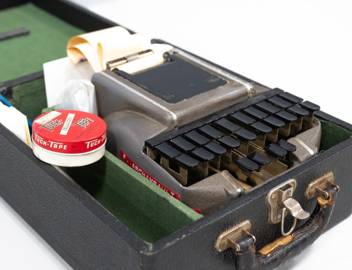An open case showing a stenotype machine.