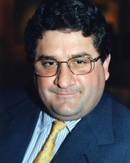 JvanLogg's tweet photo. Roger Brett Kebble was a prominent and highly controversial South African mining magnate, political financier, and art patron. 

Born in Springs, South Africa, he was the son of Roger Kebble, a rugged mining engineer. He attended St Andrew's School in Welkom and later graduated with a law degree from the University of Cape Town in 1988.

Kebble left the legal field in 1991 to join his father in the mining industry. He quickly gained a reputation for a "gung-ho, devil-may-care attitude". 

In 1991, he purchased a controlling stake in Rand Leases Gold Mining. By 1994, he engineered a takeover of Randgold & Exploration, subsequently listing Randgold Resources on the London Stock Exchange.

In 1996, he acquired a controlling stake in Johannesburg Consolidated Investment (JCI), one of the country's oldest mining houses.

By the early 2000s, Kebble's empire began to collapse under a web of massive corporate deception. 

He established complex shell companies and slush funds to hide billions in liabilities and fund his lavish lifestyle. 

He secretly looted and sold millions of shares in Randgold Resources to keep his other failing enterprises afloat, nearly destroying mining companies like Western Areas.

Facing heavy institutional scrutiny, share price manipulation charges, and tax evasion allegations, Kebble was forced to resign from his positions at JCI and Randgold in August 2005. 

At the time of his death in September 2005, he was under intense regulatory scrutiny, had been forced to resign from his companies, and was being investigated by the National Prosecuting Authority (NPA), South African Revenue Service (SARS), and external forensic auditors. While he faced earlier, separate legal indictments regarding share price manipulation in the early 2000s, he died before a full criminal trial for his massive corporate collapse could take place. 

On 27 September 2005, Kebble was found shot dead in his Mercedes-Benz in Melrose, Johannesburg. 

Initially treated as a high-profile political assassination or carjacking, a subsequent National Prosecuting Authority (NPA) investigation revealed a bizarre tale. Kebble had apparently “orchestrated his own murder”. It goes that he was depressed, faced financial ruin, and facing imminent arrest, and then hired hitmen through his security chief to stage a carjacking so his family could collect on his life insurance policies.

The self-confessed hitmen (Mickey Schultz, Nigel McGurk and Faizal “Kappie” Smith) received immunity through plea bargains. Kebble’s associate, Glenn Agliotti, was put on trial for the murder but acquitted. It also exposed deep-seated corruption, revealing that Agliotti had paid bribes to South Africa's National Police Commissioner, Jackie Selebi, for protection.  Forensic audits conducted immediately after his death revealed that Kebble and his associates had stolen and secretly sold 21.8 million shares of Randgold Resources (valued at roughly R2 billion at the time) belonging to Randgold & Exploration (R&E). He channeled this cash into opaque slush funds to prop up his other failing mining ventures (like JCI and Western Areas) and to fund his lavish lifestyle.

In the years following his death, the corporate fallout ballooned drastically. R&E originally launched a legal claim against JCI for R1.1 billion, which they later revised to over R5 billion as more fraud unraveled. Investigative authors and civil claimants subsequently calculated the total societal and corporate destruction - including tax evasion, market manipulation, and collapsing share values - to be worth between R5 billion and R26 billion.

SARS lodged a claim against his insolvent estate for R183 million.
