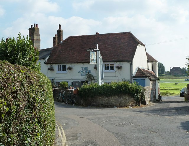 MabelReviewsGB's tweet photo. Bosham’s spring tide turned my pause into a regatta.

In Bosham, West Sussex, I only meant to sit for five minutes on Quay Meadow. Then a rowing crew slipped between moored boats and swans as water pressed through gaps in the harbour wall.

I followed the quay to the family-run Anchor Bleu, where bicycles leaned against the wall and the creek sat just beyond the pub. That small detour changed the place for me: meadow, quay and pub are not scenery. They let a village gather around its working water-and that everyday access deserves protecting.