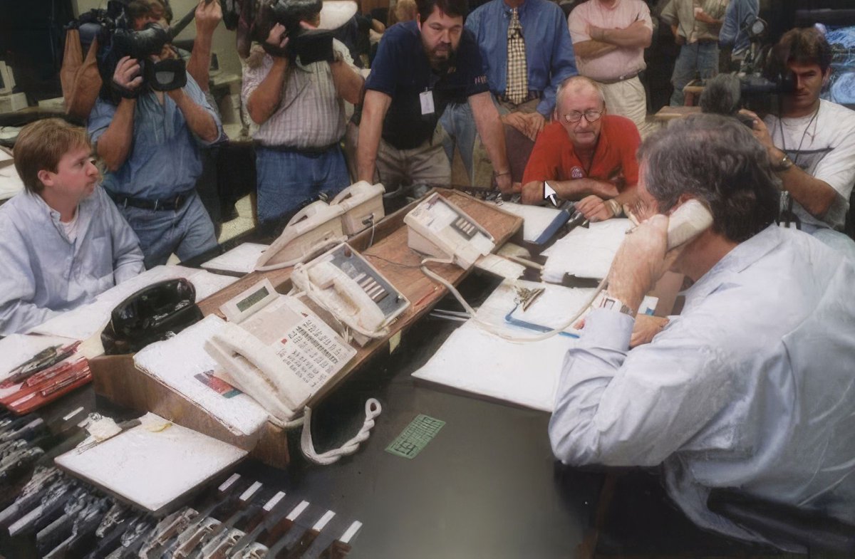 This colorful photo shows reporters filming Hurricane Specialist Richard Pasch making a hurricane conference call with the National Weather Service New Orleans/Baton Rouge Office during Hurricane Katrina in 2005. Digitally enhanced photo. (Image credit: NOAA)