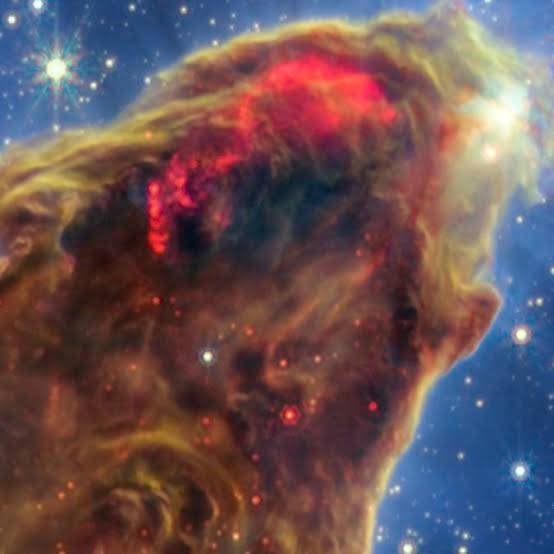 RKS1269930's tweet photo. Title: The Ghostly Loom of Creation... 🌌🔥Look closely at this towering cosmic monolith [image_3Wdjno.png]. It is not just gas and dust floating in the void; it is the ancient, bleeding edge of time itself.Captured in unparalleled detail, this close-up of the Pillars of Creation exposes a haunting reality that has been unfolding 6,500 light-years away. To an analytical eye, this dark, dense ridge looks less like a random nebula and more like a massive, structured furnace forging the building blocks of existence from absolute first principles.The Crimson Wound (The Supersonic Jet):Notice that terrifying, vibrant red glow bleeding through the dark golden dust at the top. It looks like an open cosmic wound, but the truth lies in its calculated execution. Deep inside that thick shroud of darkness, invisible newborn stars have just ignited. In their first moments of life, they are violently vomiting supersonic jets of raw energy, slicing through the dust clouds like cosmic knives at thousands of miles per second.The Unseen Architecture:What we see as pillars are actually massive elephant trunks of interstellar matter, so colossal that our entire solar system would be nothing more than a speck of dust inside them. The blinding white stars piercing through the blue void aren't just background decorations—they are the silent architects of this nebula, slowly consuming it from the outside while new life gestates within."We look into the deep universe to break reality down to its core components, only to realize that we are staring into a beautiful, calculated chaos that has been executing the masterclass of creation long before we ever learned to look up."#PillarsOfCreation #JamesWebb #DeepSpace #CosmicGlow #StarGenesis #FirstPrinciples #UniverseSecret #Execution
