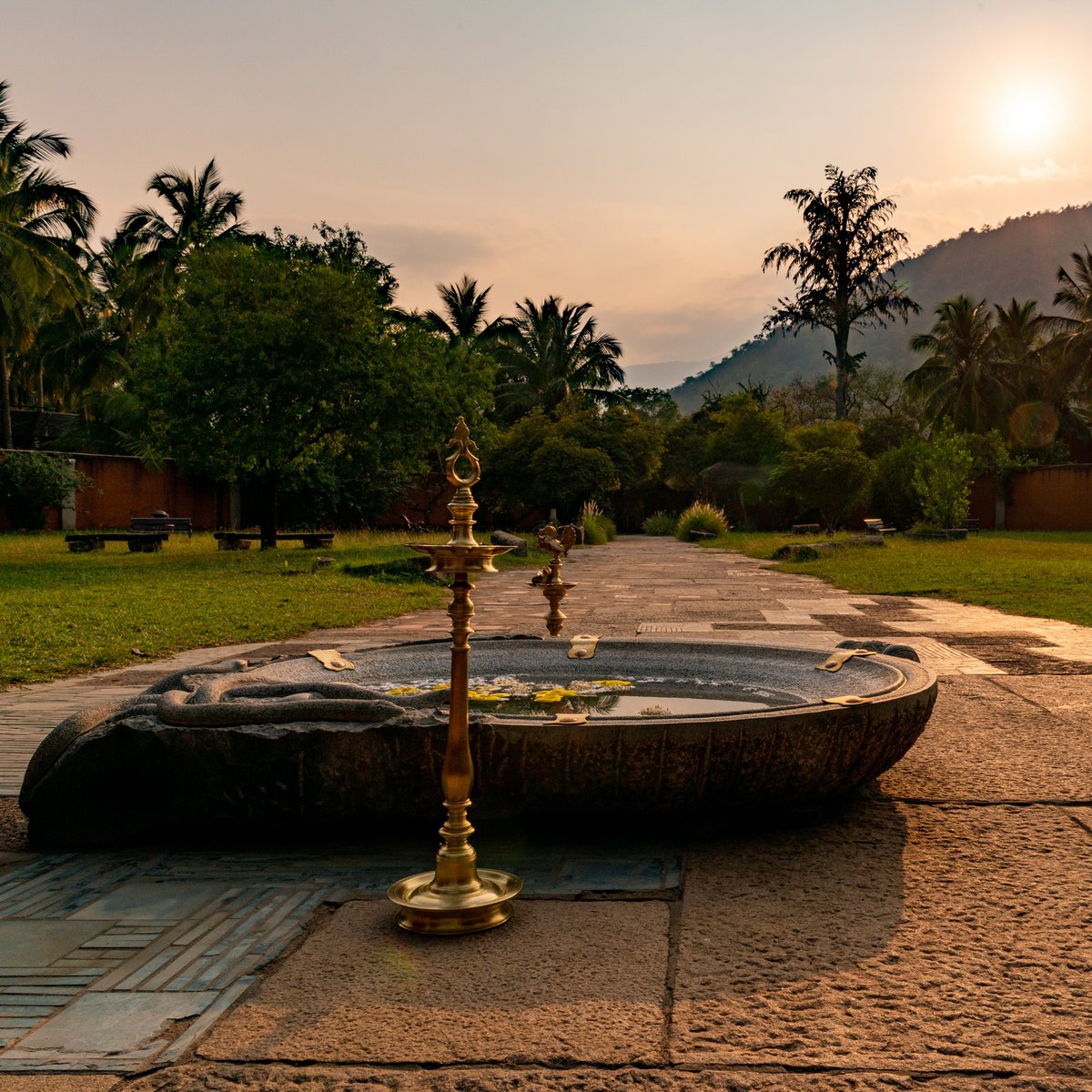 ishafoundation's tweet photo. The sun sets behind the Velliangiri mountains, and the Isha Yoga Center settles into a golden evening. https://t.co/TdnjSO2rjF