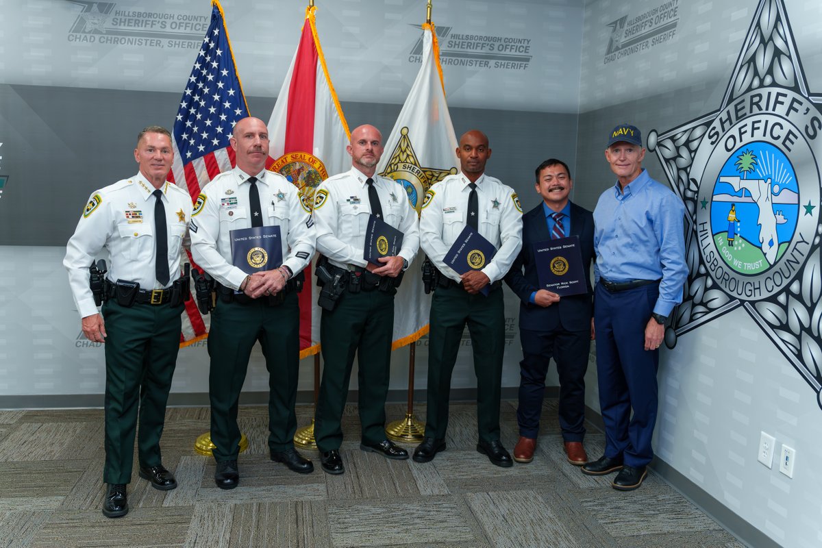 HCSOSheriff's tweet photo. Sheriff Chad Chronister was joined by Senator Rick Scott as he recognized Corporal William Barnes and Deputies Colton Daniels, Roody Louis, and Sopharmony Muon for their courage during the July 16 ambush in Ruskin.
“Senator Scott was one of the first to call and check on our deputies that day,” said Sheriff Chronister. “We are grateful for his continued support and for recognizing the courage and sacrifice of these four members of #teamHCSO.”
We are proud of their selflessness and dedication to protecting Hillsborough County. 💚