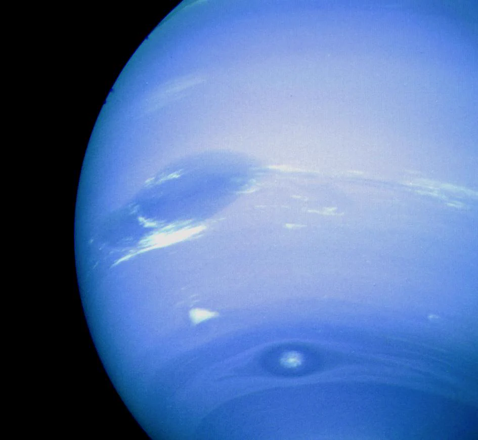 Closeup of Neptune where the planet takes up 3/4 of the frame. Storms and clouds are visible on this bluish gas giant.