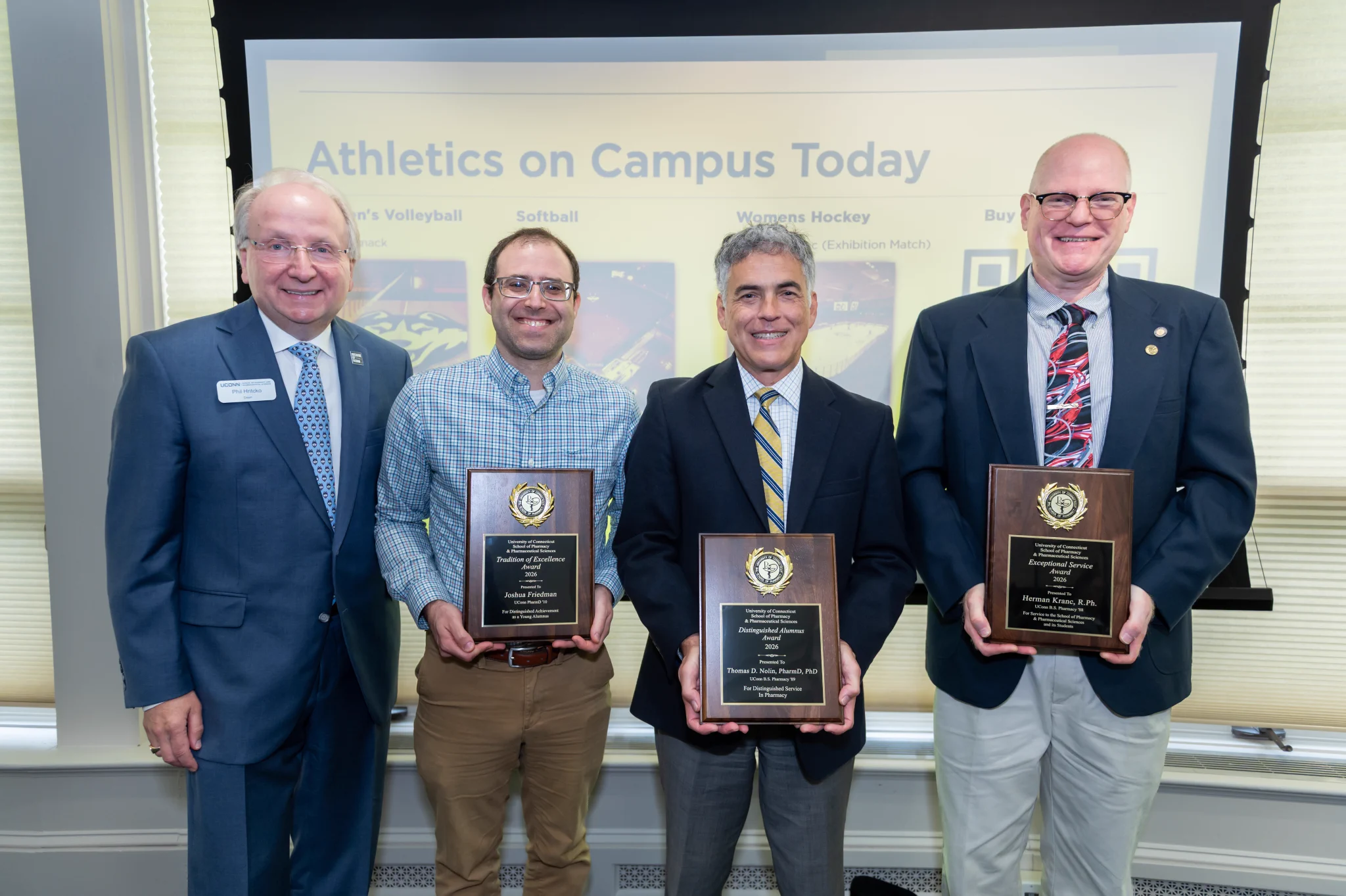The Dean and 3 men posing with awards.