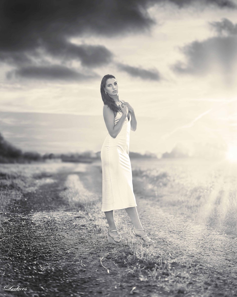 HaileyBenkitt's tweet photo. Dressed in golden hues against the dusky evening, she stands elegant and serene. The sunset highlights every detail, blending seamlessly with the moody, painted sky. Spring feelings, happy. https://t.co/XGqIsbr7dT