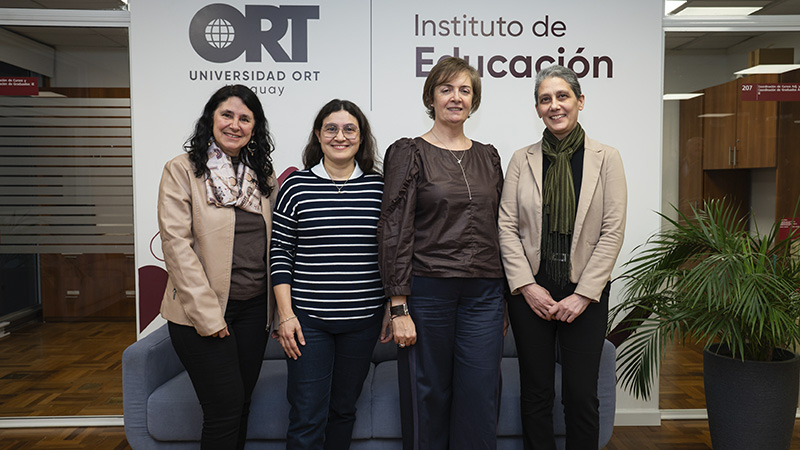 Dra. Claudia Cabrera Borges, Mag. Cecilia Belletti, Dra. Andrea Tejera Techera y Dra. Mariela Questa-Torterolo posan frente al panel del Instituto de Educación de la Universidad ORT Uruguay.