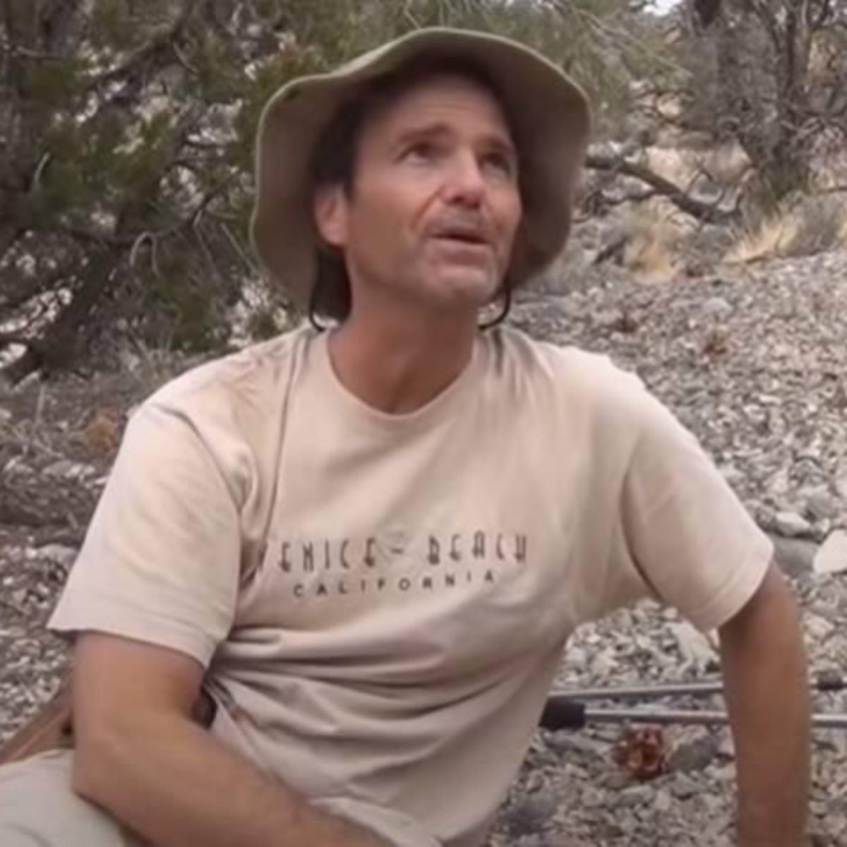 creepydotorg's tweet photo. In November 2014, 47-year-old YouTuber Kenny Veach drove into the Nevada desert to search for a hidden cave.

He never came back.

Earlier that year, Kenny had left a strange comment under a video about Area 51. He said that while hiking near Nellis Air Force Base, he had found a cave entrance shaped like a perfect capital M.

As he got closer to it, his entire body began to vibrate uncontrollably, and a sudden wave of terror forced him to turn around and run.

When viewers accused him of making up the story, Kenny hiked back into the mountains with a camera to prove them wrong.

He failed to find the cave but posted the footage anyway. In the comments, someone left a chilling warning: "Do not go back there. If you find that cave entrance, don't go in, you won't get out."

Kenny ignored it.

On November 10, he packed for an overnight trip and headed back into the desert for one final search.

When he failed to return, search and rescue teams began looking for him.

His car was found at the trailhead. Then, on November 22, searchers found his phone near an abandoned mine shaft, roughly a four-hour hike from the vehicle.

It was the same shaft he had shown in his earlier video. But there was no sign of Kenny.

More than ten years later, he remains missing. No one knows whether he ever found the cave again.