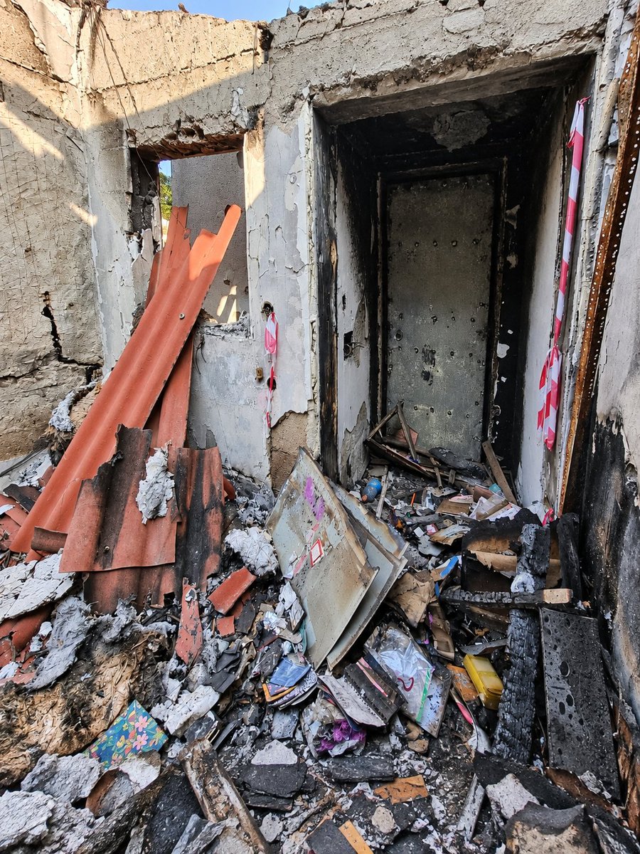 NoaMagid's tweet photo. On October 7, Ohad Cohen, his wife Sandra, and their three children - Liam, Dylan, and nine-month-old Mila - were trapped in the safe room of their home in Kibbutz Be’eri.

When terrorists broke into the house and tried to force their way into the safe room, Ohad held the door and fought to protect his family. Even after he was shot through the door in both legs, he refused to give up. The terrorists fired into the room, murdering baby Mila and severely wounding Sandra. Ohad called for help, begging for someone to rescue them. Help never came.

Then the terrorists set the house on fire. When the family could no longer breathe, Ohad pulled himself up using his hands, opened the window, and helped Sandra get the boys out. As they tried to escape, Ohad was shot and murdered. Nothing was left of their home.

Sandra and the boys eventually managed to hide and were evacuated only in the evening.

Sandra later said of Ohad: "He saved us. He was so brave and never gave up for a moment."

At the same time, Ohad's mother, Yona, 73, was also murdered in her home in Be’eri. For days, the family did not know what had happened to her.

Ohad and his nine-month-old daughter Mila were buried together, beside Yona.

On Ohad and Mila's gravestone, their loved ones chose words from the Pink Floyd song he loved:

"Shine on you crazy diamond."

I took the last two photos at their home after the massacre.