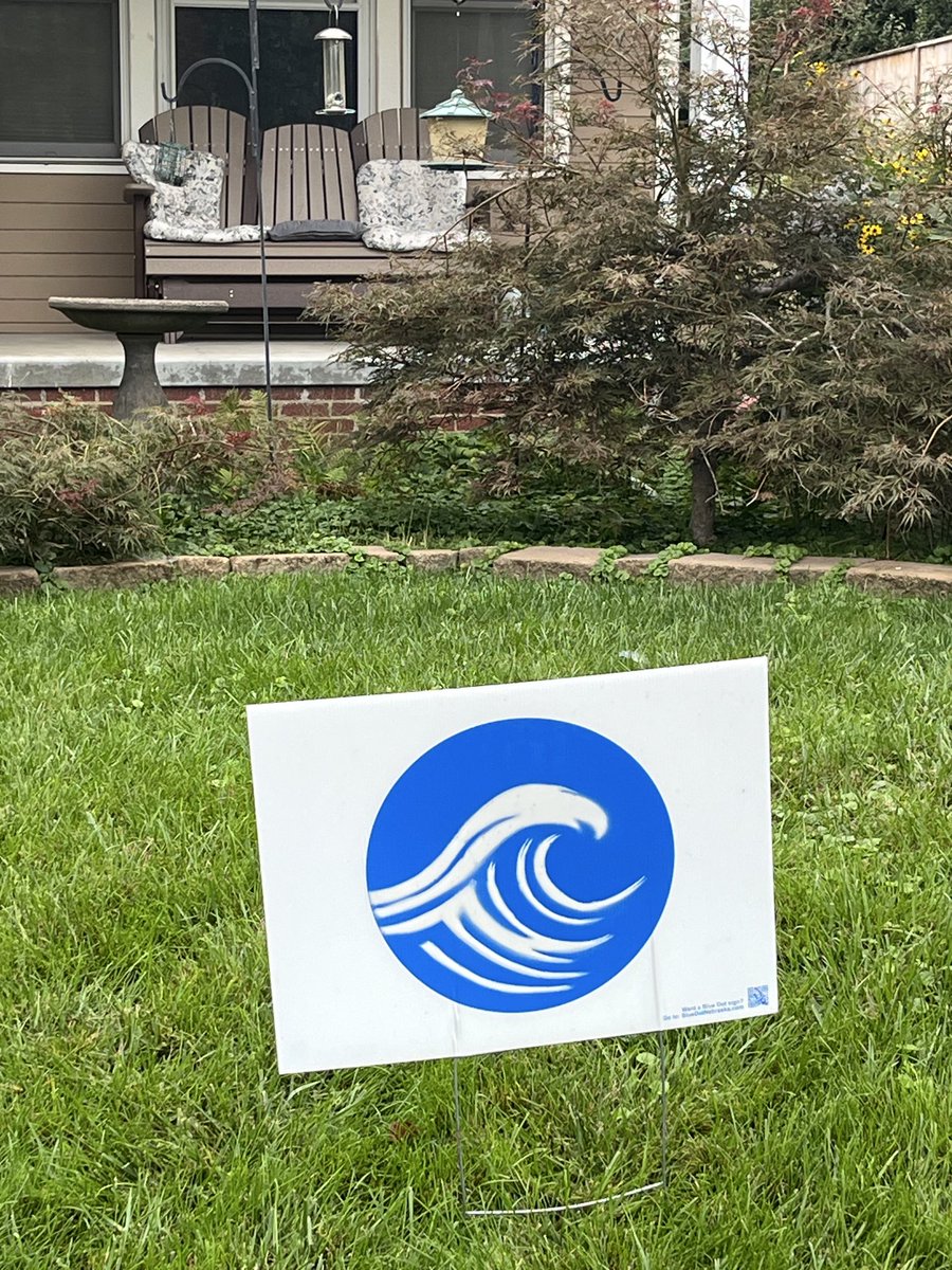 KBAndersen's tweet photo. I’m spending the week in Omaha, my now-Democratic hometown in red Nebraska. In 2024 their genius election yard sign was the elegant blue dot. This time in yard after yard it’s the blue dot with a wave. https://t.co/IDbspoeYKB