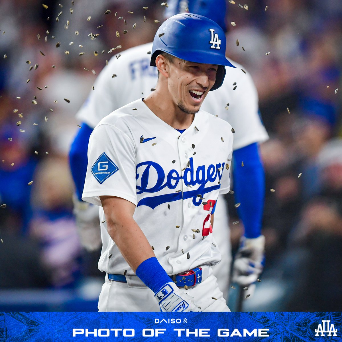 A photo of Tommy Edman getting sunflower seeds thrown at him after he hit a home run.