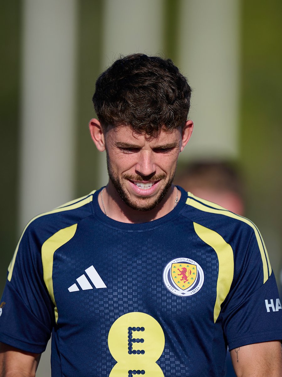 Ryan Christie smiles in training whilst wearing Scotland training kit.