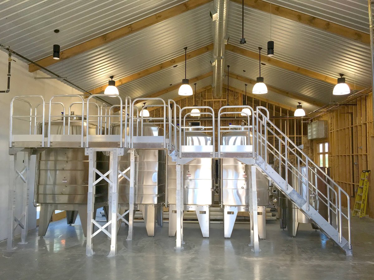 ErectaStep's tweet photo. At Michael Angelo’s Winery, an ErectaStep mill-finish catwalk gave crews a defined route to wine vats for process work and sampling. Bring wet-room tank access challenges to the ErectaStep team. #Winery #Catwalk #Erectastep https://t.co/Vv9Xh6JP7X