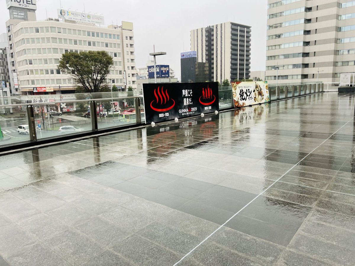 harune_log's tweet photo. 高崎駅東口にもBUCK-TICKの看板♨️

雨に濡れたデッキに黒と赤の看板が映えてた✨

群馬のあちこちでBUCK-TICKに出会えるのはうれしいね！

#BUCKTICK #高崎駅 #群馬 https://t.co/6yn5qTBwUE
