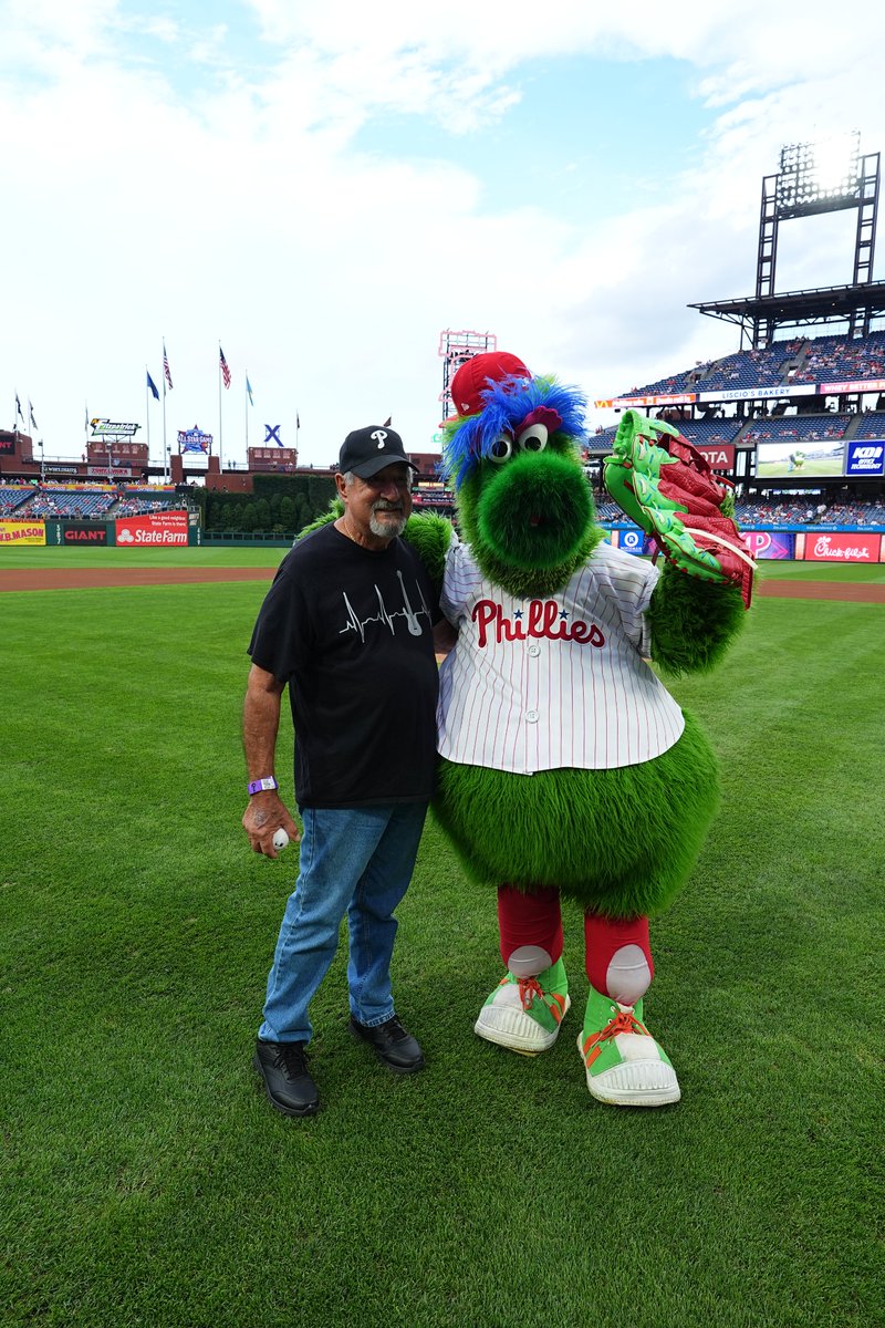 Tony DiMattia poses for a photo with the Phillie Phanatic after throwing the ceremonial first pitch.