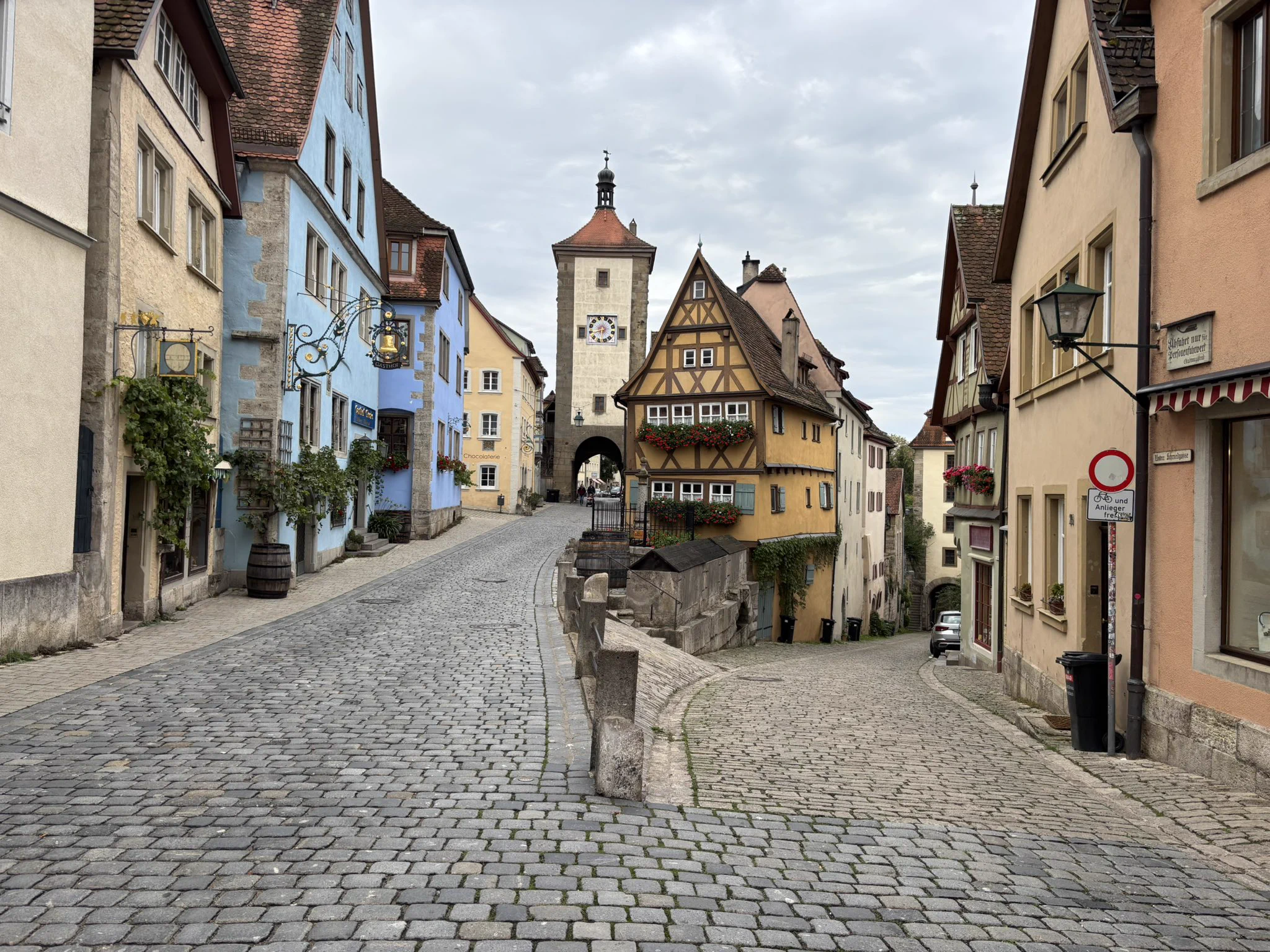 The Plönlein in Rothenburg, with colorful half‑timbered houses and a cobblestone street leading to a medieval clock tower.