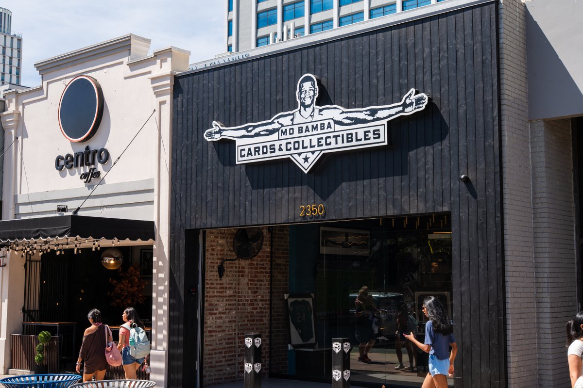 Image of the storefront of the new Mo Bamba Cards & Collectibles on Guadalupe, featuring a sign of Mo Bamba. Photo by Caleb Grijalva.