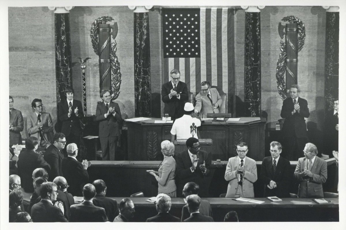 50YearsAgoLive's tweet photo. Liberian President William Tolbert addresses a joint session of U.S. Congress. 

During the speech, U.S. Speaker of the House Carl Albert, not realizing that his microphone is on, remarks to Vice President Nelson Rockefeller “he [Tolbert] would be a slave he he was in the [American] South.” 

Rockefeller laughs, and all of Congress hears.