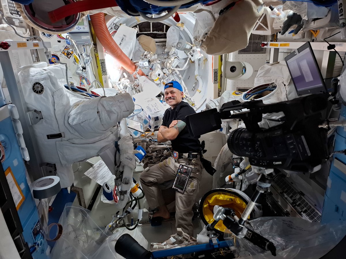 NASA astronaut and Expedition 75 flight engineer Anil Menon smiles for a portrait while conducting spacesuit maintenance inside the International Space Station's Quest airlock. Menon cleaned the spacesuit’s water-cooling loops that keep a spacewalker comfortable while working in the extreme environment of space.