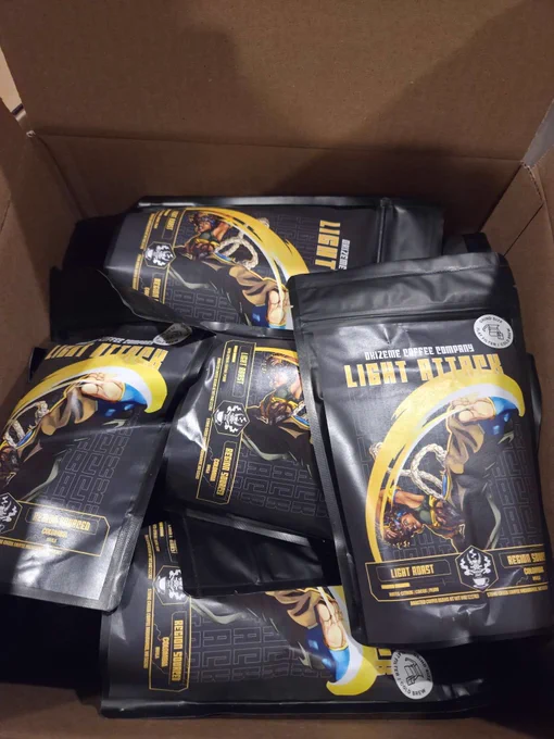 A box of bags of Light Attack featuring the Capoeira Fighter and their Sweeping Kick. The White Sticker indicates that the bag has been Pre-Grounded.