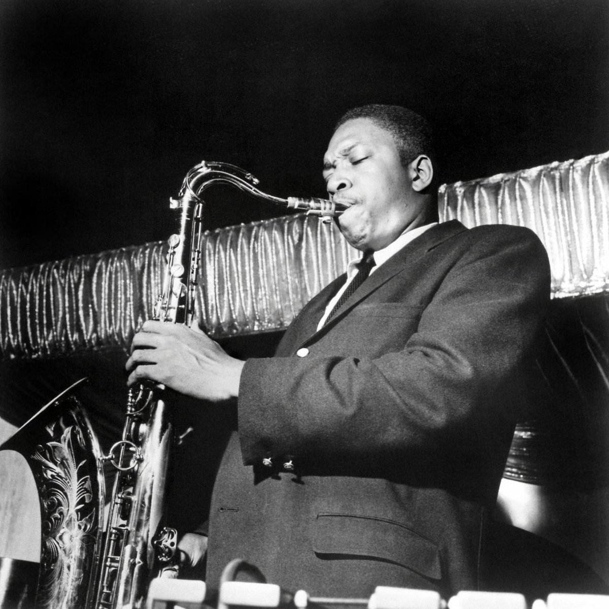 stereogum's tweet photo. Today marks 100 years since the birth of John Coltrane, the saxophone genius whose playing changed the face of jazz. As part of the celebration, the fabled ‘Tiberi Tapes’ will be officially released after six decades.

Believing that Coltrane’s studio albums could not sufficiently capture his essence, saxophonist Frank Tiberi sought to study Trane’s incomparable technique by surreptitiously recording his live performances.

Between the summer of 1960 and Coltrane’s death in 1967, Tiberi brought a small condenser microphone and a portable reel-to-reel machine called a Concertone TR-100 Transicorder to dozens of Coltrane shows in New York and Philadelphia. He hid the reel-to-reel in a cloth bag on his lap and put the microphone under his coat, switching tapes by hand without looking in the bag when performances ran long. When all was said and done, Tiberi had more than 80 reels containing over 26 hours of Coltrane performances.

Tiberi kept his tapes to himself, intensely studying them and incorporating them into his own playing and teaching. But in the years after Coltrane’s death, word got around about the guy with the massive archive of unheard Coltrane live tracks. The recordings have since taken on mythic status, and some of them are finally coming out this fall.

On Nov. 6, ‘The Tiberi Tapes’ will be available in 4-LP, 3-CD, and digital formats through Impulse! Records. The box set includes 11 recordings, starting with two versions of “Giant Steps” at radically different tempos, 226 and 262 BPM. The slower of those two is out today for you to marvel at not just the music but the 1960s audience chatter.

[📷: ©Dalle/Cache Agency]